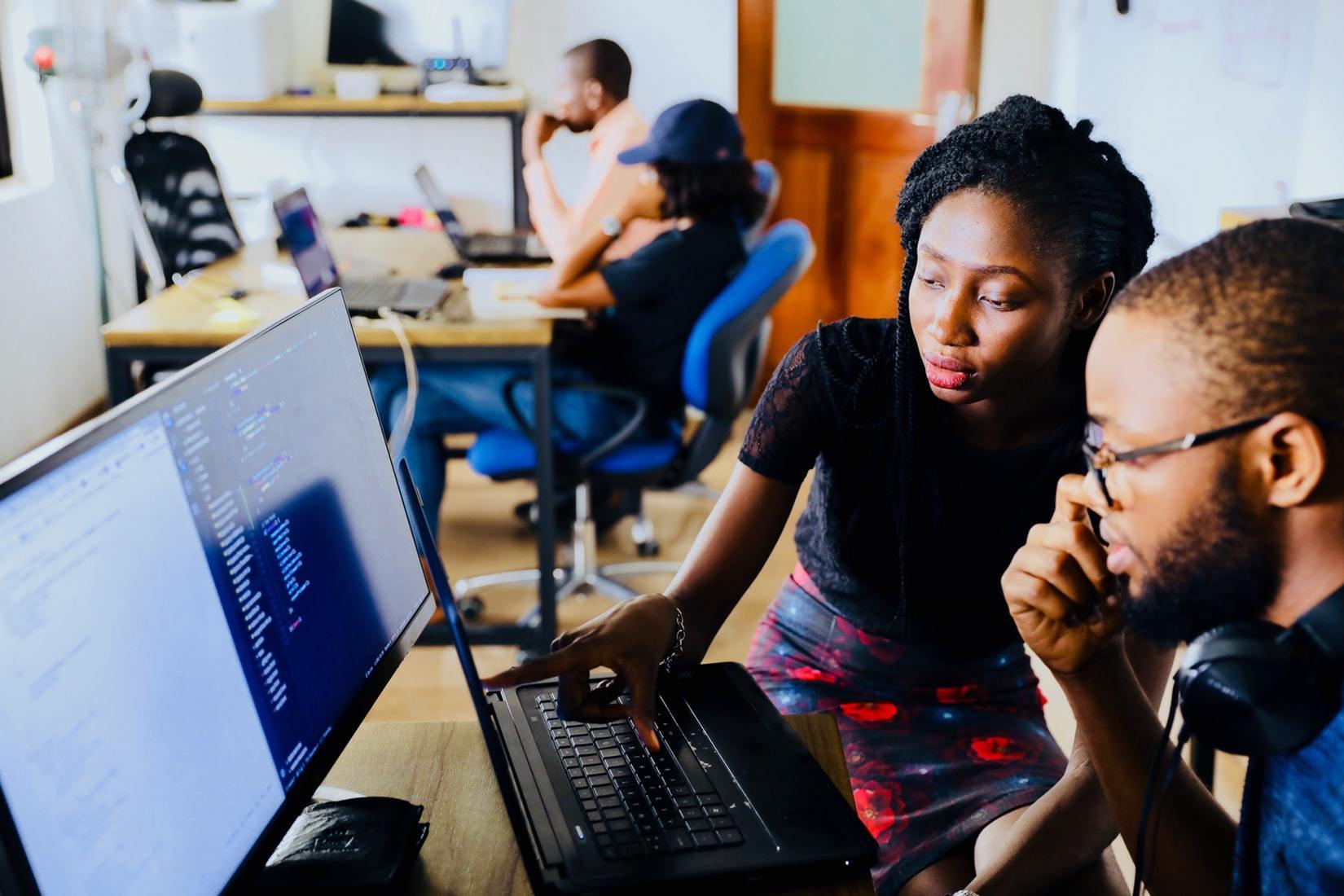 two people looking at computer together